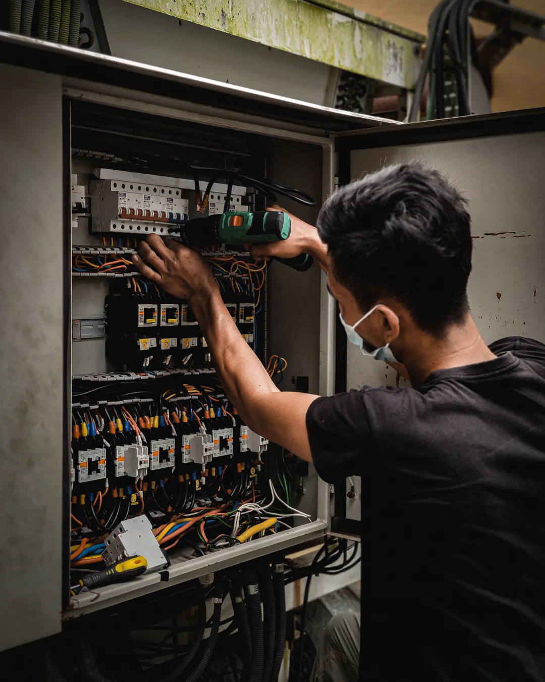 Electrician working on a circuit breaker
